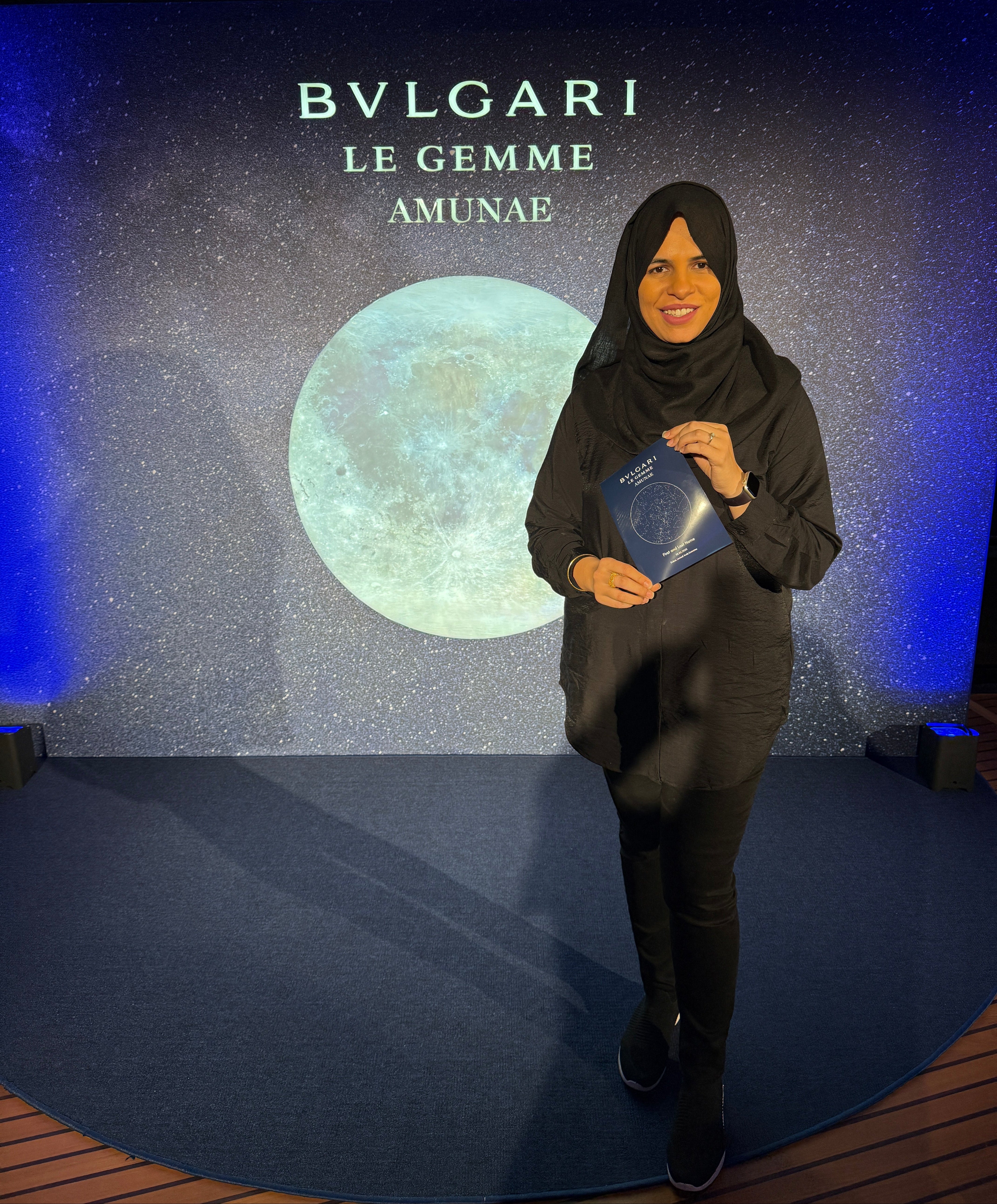 Person holding a customized Bulgari star map against a dark background with 'Bulgari Le Gemme' text.